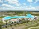 Aerial view of the community lagoon, featuring water activities, sandy beaches, and convenient parking at 31398 Penny Surf Loop, Wesley Chapel, FL 33545