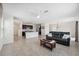 Open-concept living area with tile flooring seamlessly connects the living room, dining, and kitchen at 31398 Penny Surf Loop, Wesley Chapel, FL 33545