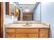 Bathroom featuring light wood vanity with sink, mirrored medicine cabinets, and neutral paint at 3243 Gretna Dr, Spring Hill, FL 34609