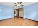 Bedroom featuring blue walls, light floors, closet, and window providing natural light at 3243 Gretna Dr, Spring Hill, FL 34609