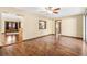 Bright living room featuring hardwood floors, ceiling fan, and view of the front entry at 3243 Gretna Dr, Spring Hill, FL 34609