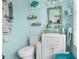 Coastal themed bathroom featuring bright blue walls and white vanity at 3251 Shoal Line Blvd, Hernando Beach, FL 34607