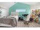 Bedroom featuring a vaulted ceiling, accent wall, and a comfortable workspace at 3251 Shoal Line Blvd, Hernando Beach, FL 34607