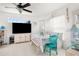 Dining area featuring bright white walls, natural light, and a unique blue accent chair at 3251 Shoal Line Blvd, Hernando Beach, FL 34607
