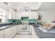 Bright kitchen featuring white cabinetry, ample countertop space, and teal backsplash at 3251 Shoal Line Blvd, Hernando Beach, FL 34607