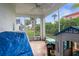 Relaxing screened patio with tile flooring, fan, and neighborhood views at 3251 Shoal Line Blvd, Hernando Beach, FL 34607