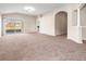 Open-concept living room featuring neutral colors and large sliding glass doors at 3877 Crossline Dr, Spring Hill, FL 34609