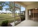 Relaxing screened-in patio boasting scenic golf course views and access to interior, perfect for enjoying the outdoors at 4431 Caliquen Dr, Brooksville, FL 34604