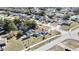 This aerial photo shows a house with an enclosed pool area, yard space, and street access at 4560 Lamson Ave, Spring Hill, FL 34608