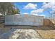 This backyard boasts an enclosed pool area with a patio, creating a private outdoor oasis at 4560 Lamson Ave, Spring Hill, FL 34608
