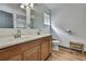 Bathroom featuring double sinks, a spacious mirror, and good natural light at 4560 Lamson Ave, Spring Hill, FL 34608