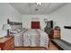Bedroom featuring a queen bed, wooden floors, dresser, and a mounted television at 4560 Lamson Ave, Spring Hill, FL 34608