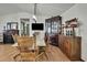 Elegant dining room with wooden table, chairs, a display case, and a fireplace in the background at 4560 Lamson Ave, Spring Hill, FL 34608