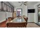 Eat-in dining area with a granite table, adjacent to a red brick accent wall and window at 4560 Lamson Ave, Spring Hill, FL 34608