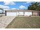 Exterior view showing a spacious garage and brick-paved driveway at 4560 Lamson Ave, Spring Hill, FL 34608
