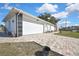 Attached two-car garage featuring a brick-paved driveway and minimalist landscaping at 4560 Lamson Ave, Spring Hill, FL 34608