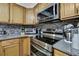 Modern kitchen featuring stainless steel appliances and dark backsplash at 4560 Lamson Ave, Spring Hill, FL 34608