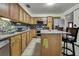 Spacious kitchen featuring light wood cabinetry, modern stainless steel appliances, and tiled floors at 4560 Lamson Ave, Spring Hill, FL 34608