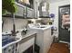 A functional laundry room with washer, dryer, sink and dark gray painted cabinets at 4560 Lamson Ave, Spring Hill, FL 34608