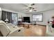 Comfortable living room featuring a ceiling fan, white sofas, and sliding glass doors to an outdoor space at 4560 Lamson Ave, Spring Hill, FL 34608