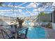 Enjoy the sun while swimming in this screened in pool with chairs and table at 4560 Lamson Ave, Spring Hill, FL 34608