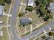 An aerial view of a single-Gathering home showcasing its neat landscaping and surrounding neighborhood streets at 520 Copperfield Rd, Spring Hill, FL 34606