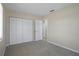 This bedroom includes neutral carpeting, closet, light paint, and a doorway leading to the rest of the home at 520 Copperfield Rd, Spring Hill, FL 34606