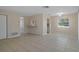 Open-concept living space with tile flooring, access to kitchen, and neutral paint throughout at 520 Copperfield Rd, Spring Hill, FL 34606