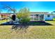 Spacious backyard view with an enclosed sunroom and beautiful plants at 5441 Mosaic Dr, Holiday, FL 34690