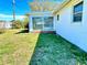 Backyard view showcasing sunroom exterior with well-maintained lawn at 5441 Mosaic Dr, Holiday, FL 34690