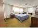 Spacious bedroom featuring twin beds, vintage lighting, and generous closet space at 5441 Mosaic Dr, Holiday, FL 34690