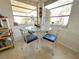 Bright breakfast nook with glass table, ornate chairs, and natural lighting at 5441 Mosaic Dr, Holiday, FL 34690