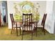 Cozy dining room featuring a round table, four chairs, and a decorative mural wall at 5441 Mosaic Dr, Holiday, FL 34690