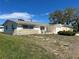 Charming home featuring an attached garage and cozy front patio with seating at 5441 Mosaic Dr, Holiday, FL 34690