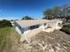 Side view of a white single-story home with a front porch and well-maintained exterior at 5441 Mosaic Dr, Holiday, FL 34690