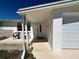 Inviting front porch with seating, leading to the front door and attached garage at 5441 Mosaic Dr, Holiday, FL 34690