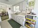 Bright kitchen with white cabinets, green countertop, and adjacent dining area at 5441 Mosaic Dr, Holiday, FL 34690