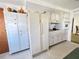 Charming kitchen with white cabinets, retro appliances and a spacious pantry at 5441 Mosaic Dr, Holiday, FL 34690