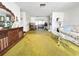 Open living space featuring vintage furniture, olive carpet and bright natural light at 5441 Mosaic Dr, Holiday, FL 34690