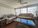 Comfortable living room featuring two sofas, large windows, and a ceiling fan at 5441 Mosaic Dr, Holiday, FL 34690