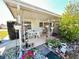 Inviting covered patio with lush garden, featuring a table and chairs for outdoor enjoyment at 5441 Mosaic Dr, Holiday, FL 34690