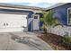 Close up of a blue home featuring well-maintained landscaping, and a white front door at 5590 77Th N Ave, Pinellas Park, FL 33781