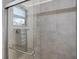 Modern shower featuring sleek gray tiling and a frameless glass enclosure at 5590 77Th N Ave, Pinellas Park, FL 33781