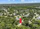 Aerial view of a house in a community nestled amongst rivers and green trees with an ocean view in the background at 6090 Waverly Rd, Weeki Wachee, FL 34607
