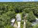 Aerial view of the property showcasing the house, lush green surroundings, and waterfront location at 6090 Waverly Rd, Weeki Wachee, FL 34607