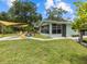 Inviting backyard patio with colorful chairs, offering a perfect spot for relaxation and outdoor entertainment at 6090 Waverly Rd, Weeki Wachee, FL 34607