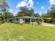 Lush green backyard with an inviting patio, offering a serene outdoor retreat at 6090 Waverly Rd, Weeki Wachee, FL 34607