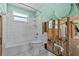 Bathroom with standard toilet, tub, shower and a light green accent wall at 6090 Waverly Rd, Weeki Wachee, FL 34607