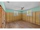 Bedroom with hardwood floors, a fan and two windows at 6090 Waverly Rd, Weeki Wachee, FL 34607