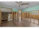 Open living room features hardwood floors, fan and a light green accent wall at 6090 Waverly Rd, Weeki Wachee, FL 34607